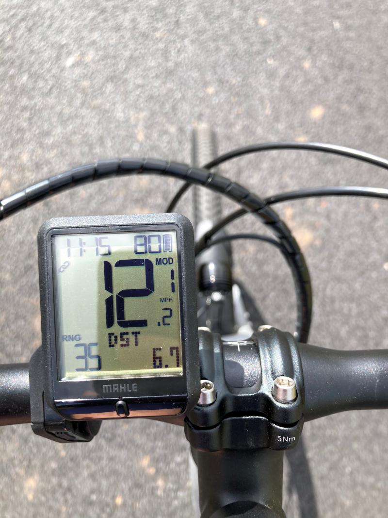 The digital display on an e-cycle mounted to its handlebars shows shows various data