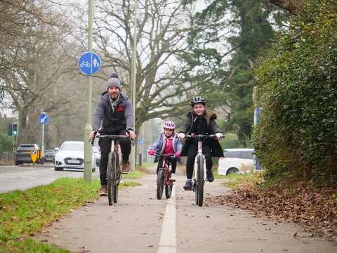 Family cycling together