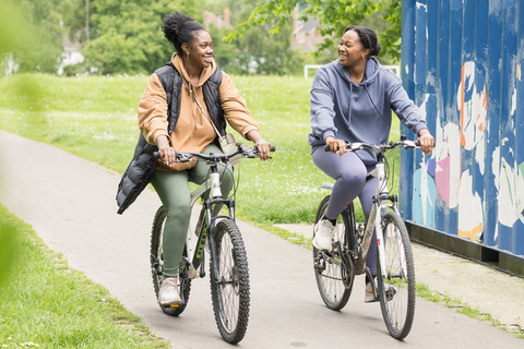 Two women riding bikes