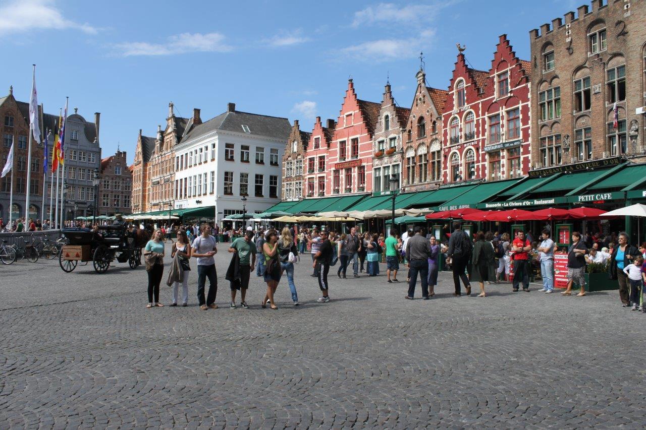 People walking around the main square in Bruges