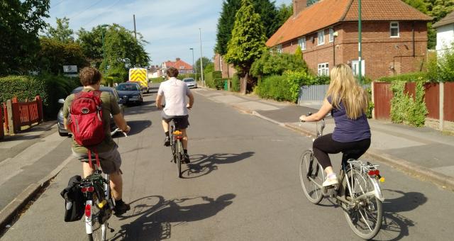 Group of friends cycling on a residential street in Nottingham