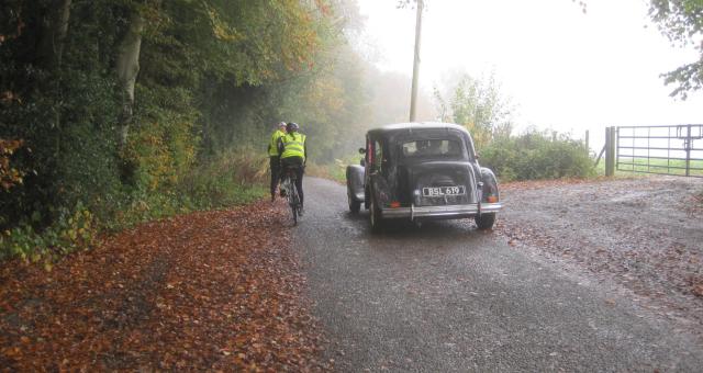 Veteran car and cyclists on a country lane