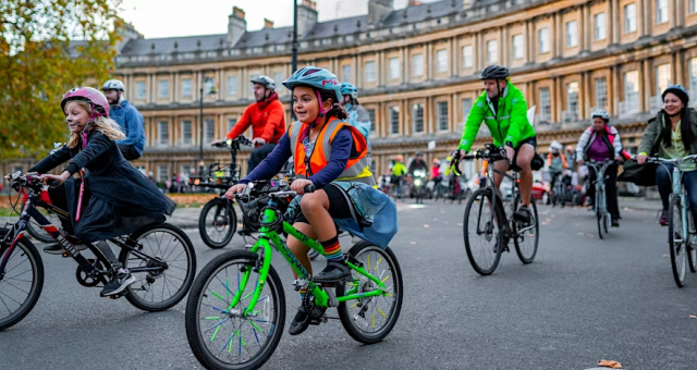 Children cycling around the Royal Crescent in Bath