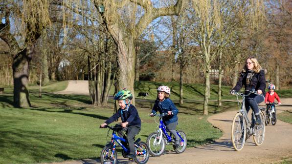 Children cycling to school with their mother