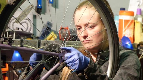 Sylvia Barnett works on a bike at the Plattfields Bike Hub