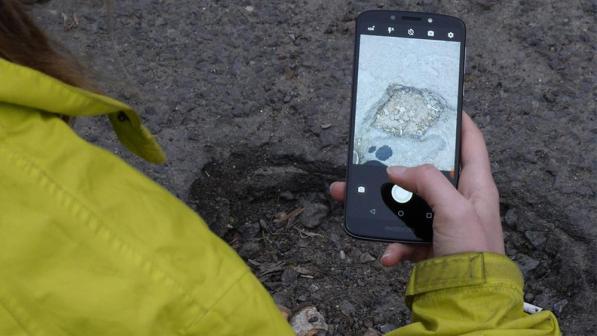 Cyclist reporting a pothole via Fill That Hole