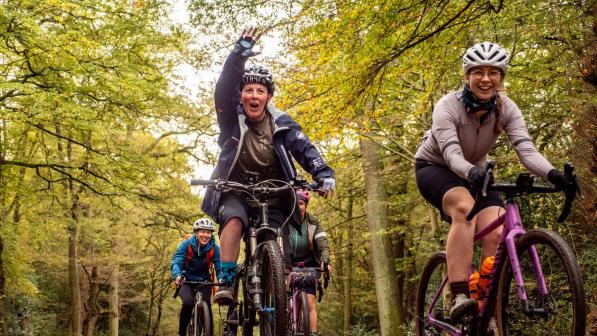 A group of women rising though a forest.